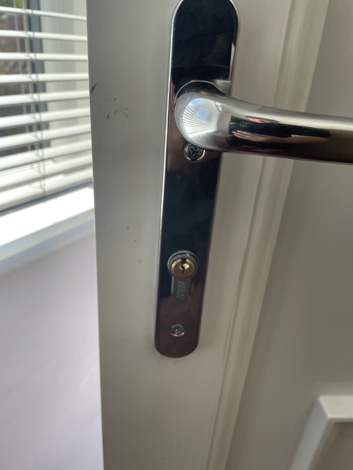 New chrome lever handle and cylinder fitted to a white uPVC door