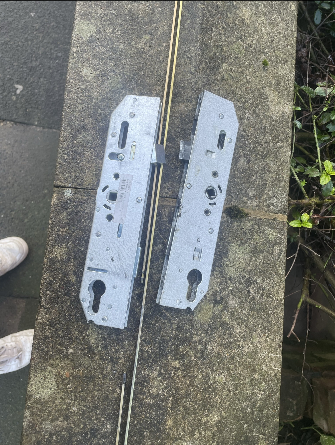 Two multipoint locking mechanisms removed from a door